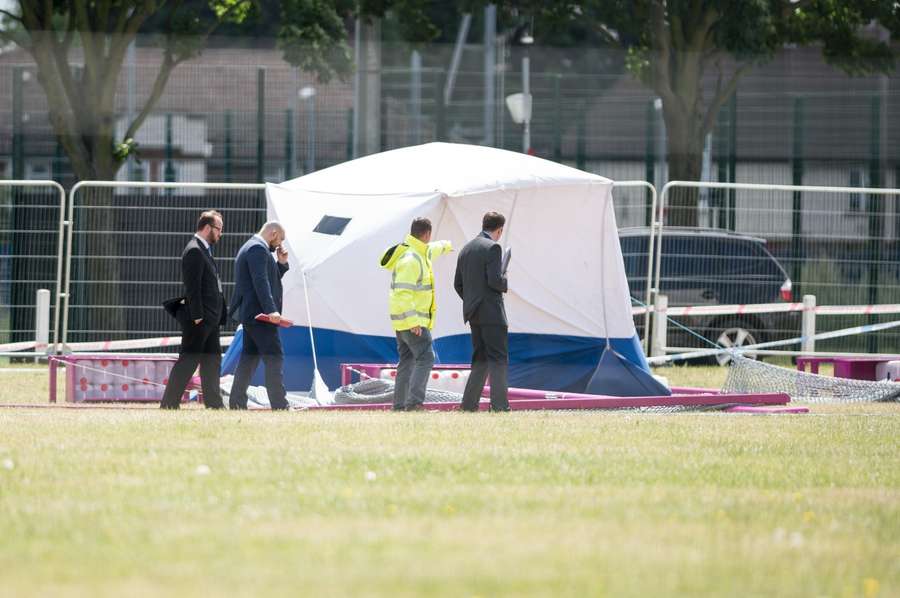 People looking over the police tent at the scene where Abdullah Hayayei died