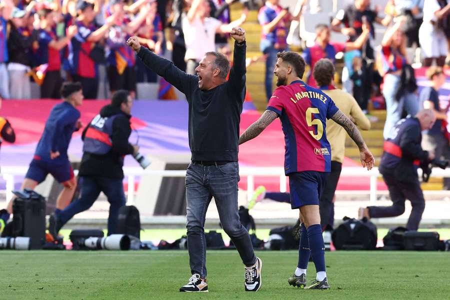 Barcelona coach Hansi Flick celebrates with Inigo Martinez after the match