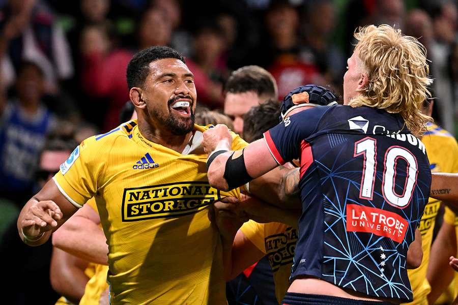 Hurricanes captain Ardie Savea (L) fights with Rebels' Aidan Morgan