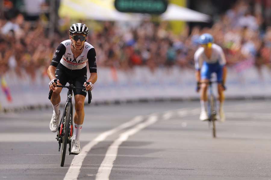 UAE Team Emirates' Adam Yates (L) cycles to the finish line to win ahead of his brother, Team Jayco Alula's Simon Yates