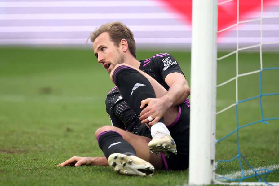 Bayern Munich forward Harry Kane holds his leg during Saturday's 5-2 win at Darmstadt