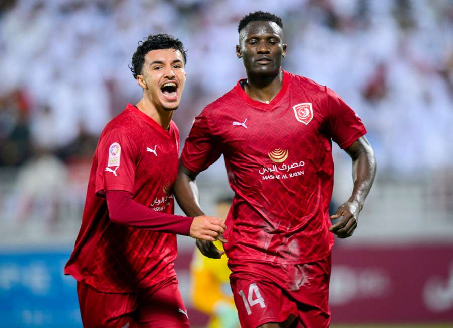 Michael Olunga (R) in action with Al-Duhail