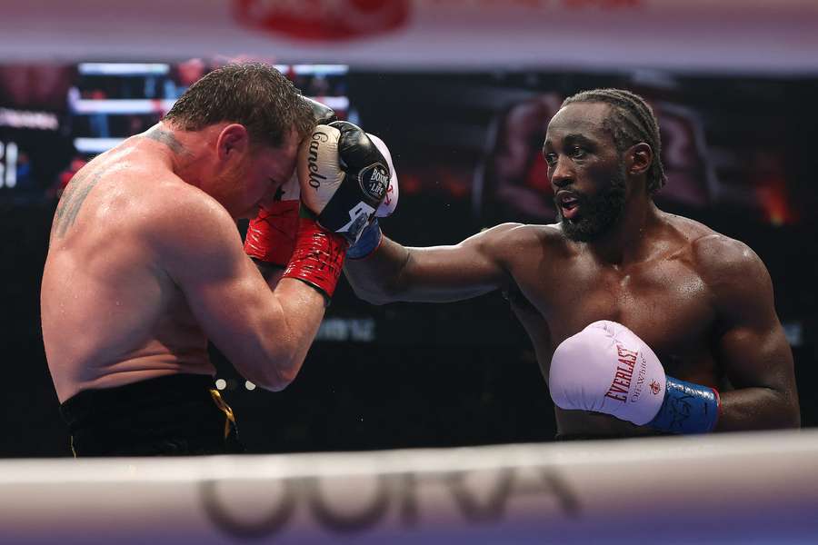 Terence Crawford (R) throws a right punch against Canelo Alvarez (L) in their undisputed super middleweight title fight