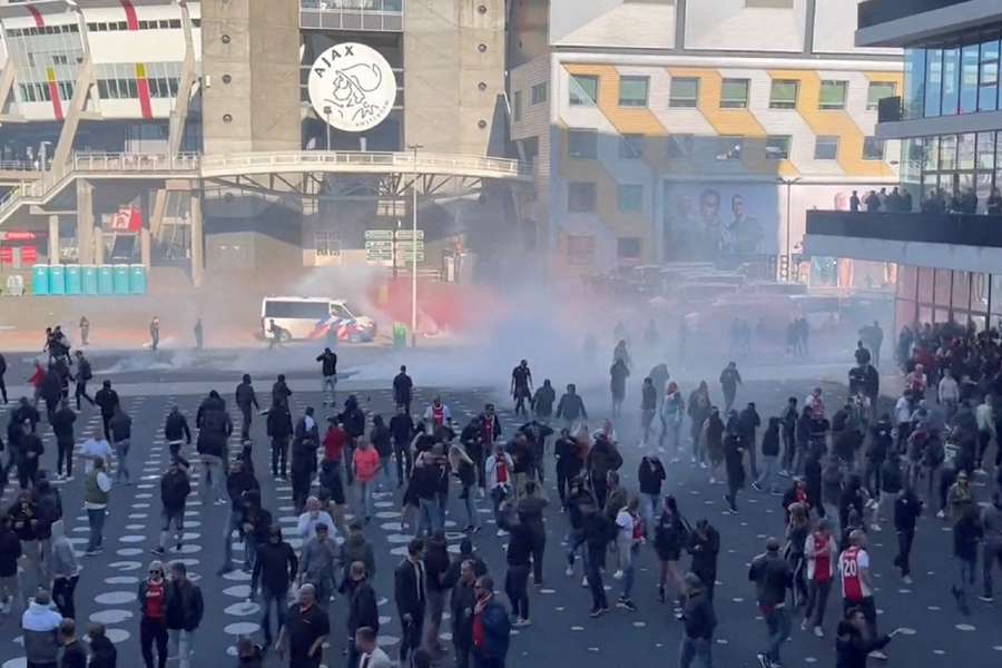 Police officers use teargas to disperse football fans rioting