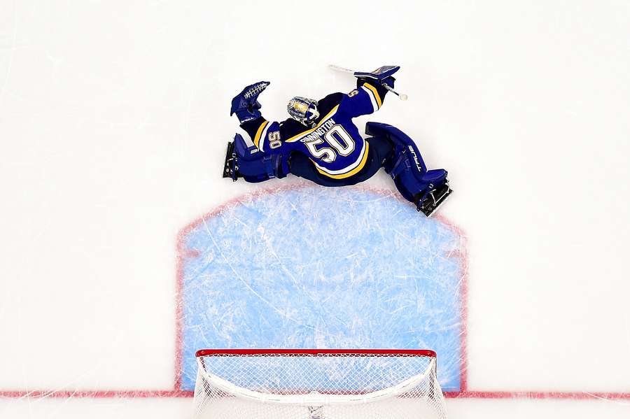 Blues goaltender Jordan Binnington makes a glove save against the Predators during overtime