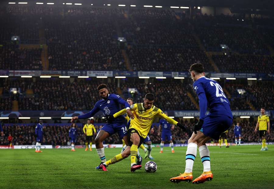 Reece James vies for the ball with Giovanni Reyna