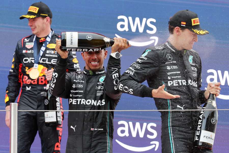 Red Bull driver Max Verstappen (L), Mercedes driver Lewis Hamilton (C) and Mercedes driver George Russell celebrate on the podium