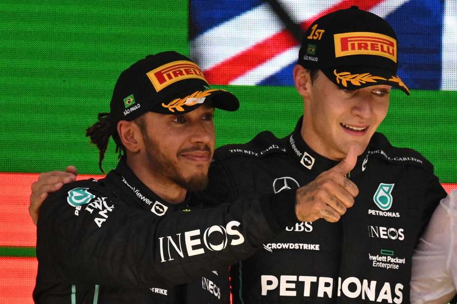 Lewis Hamilton (L) returns to the scene of last season's final race drama with a spring in his step