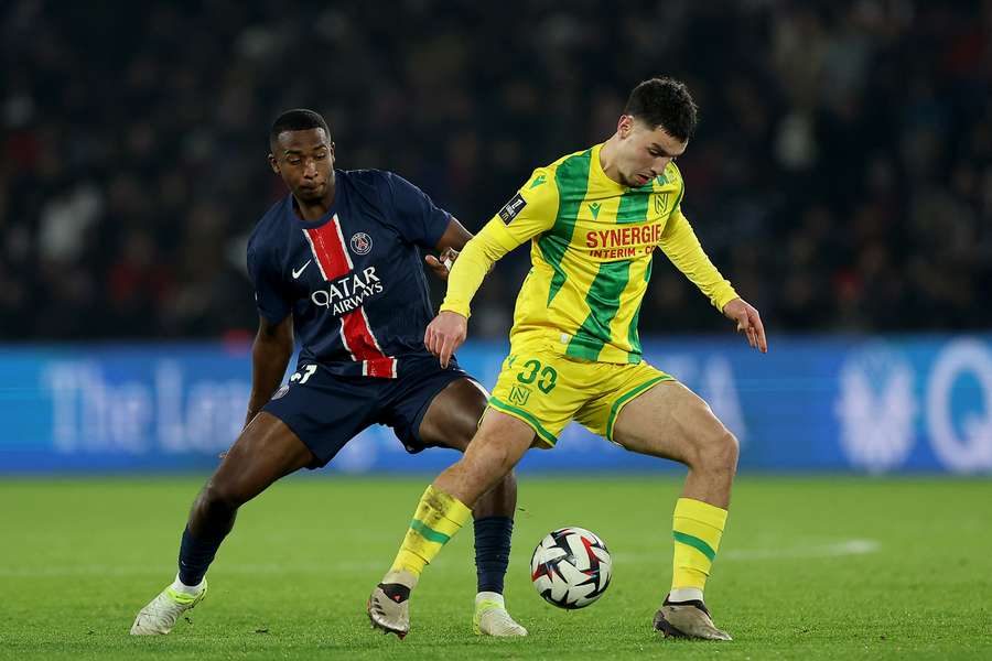 Matthis Abline, right, fights for the ball with Paris Saint-Germain's Willian Pacho 