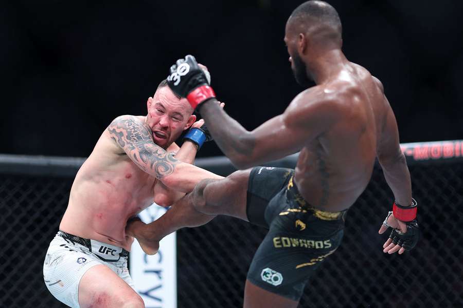 Leon Edwards of Great Britain kicks Colby Covington during their welterweight title fight