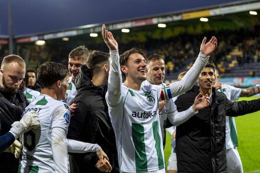 FC Groningen's David van der Werff celebrates his team's win over Fortuna Sittard with the away support FC Groningen's David van der Werff celebrates his team's win over Fortuna Sittard with the away support