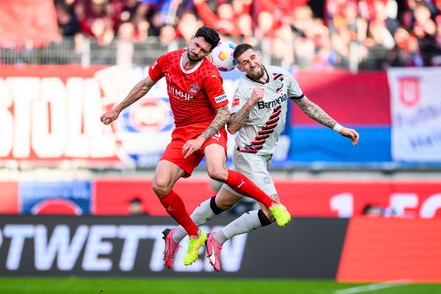 Heidenheim's Tim Kleindienst (L) in action against Leverkusen's Robert Andrich