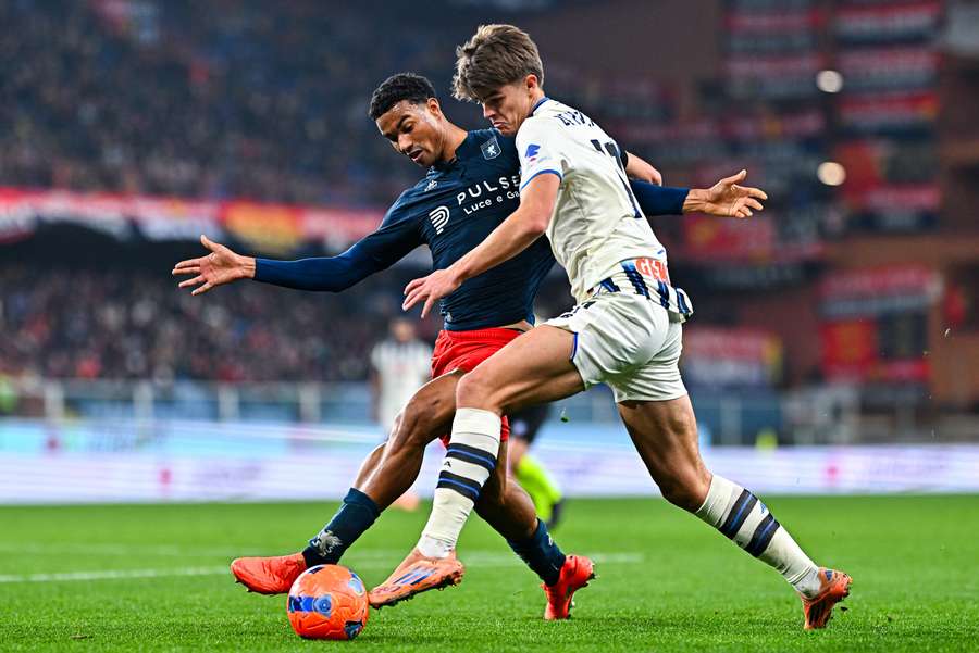 Alessandro Marcandalli of Genoa (left) and Charles De Ketelaere battle for the ball