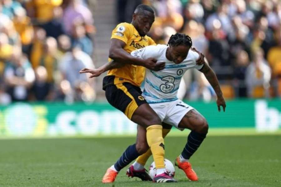 Wolves defender Tote 'Toti' Gomes (L) tackles Chelsea forward Raheem Sterling (R) in the Premier League