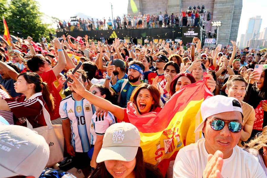 Fans react as they watch the FIFA World Cup final between Spain and Argentina at the Brooklyn Bridge park party