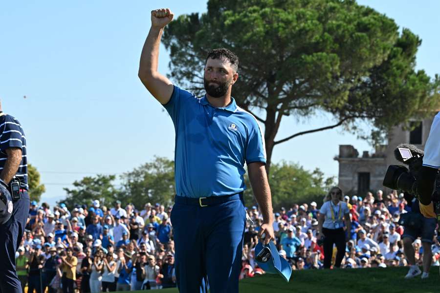 Jon Rahm celebrates on the 15th green after winning his foursomes match on the opening day