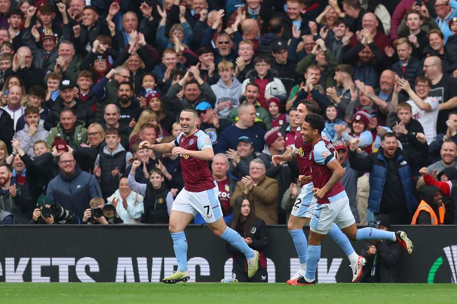 John McGinn of Aston Villa celebrates with teammates after scoring the team's first goal