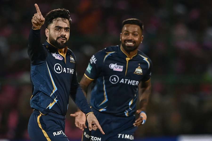 Gujarat Titans' Rashid Khan, left, celebrates with Hardik Pandya after taking the wicket of Rajasthan Royals' Ravichandran Ashwin