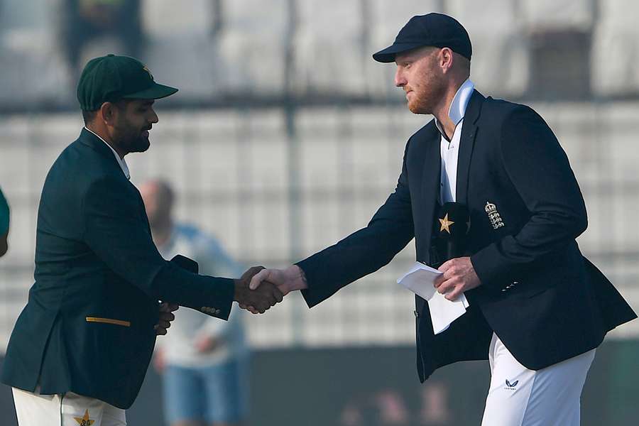 Pakistan captain Babar Azam (L) shakes hands with England captain Ben Stokes after the toss