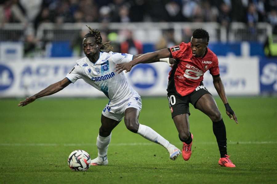 Mensah (left) battling for the ball against Rennes