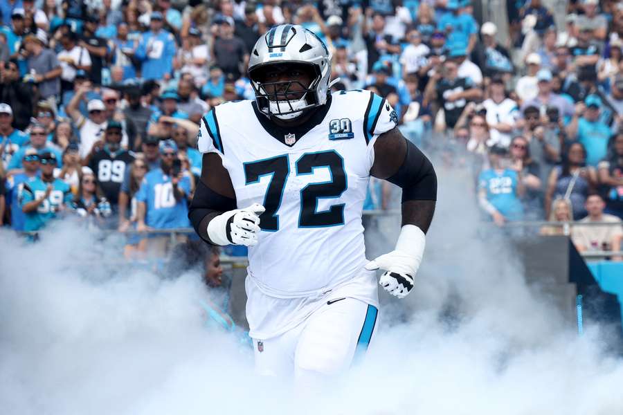 Carolina Panthers Taylor Moton running onto the field before a game (2024)