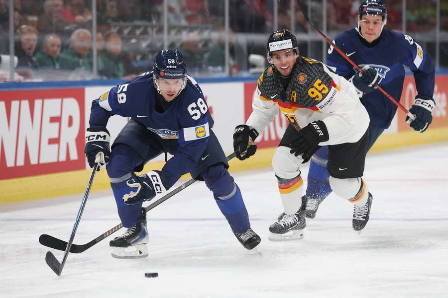 Finland's Urho Vaakanainen skates past Germany's Frederik Tiffels