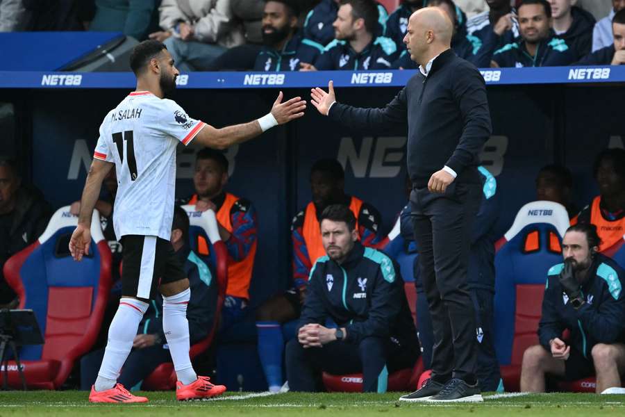 Mohamed Salah shakes hands with Liverpool manager Arne Slot