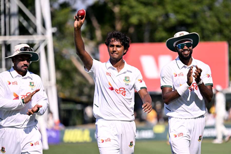 Hasan Mahmud holds the ball aloft after taking 6-55