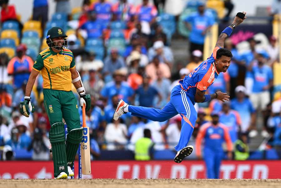 India's Hardik Pandya (R) bowls during the ICC men's Twenty20 World Cup 2024 final cricket match between India and South Africa