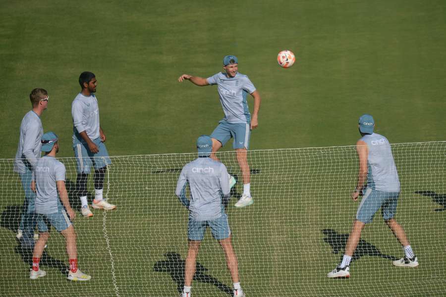 England's cricketers warm up with a football during training at Karachi's National Stadium ahead of the third Test against Pakistan