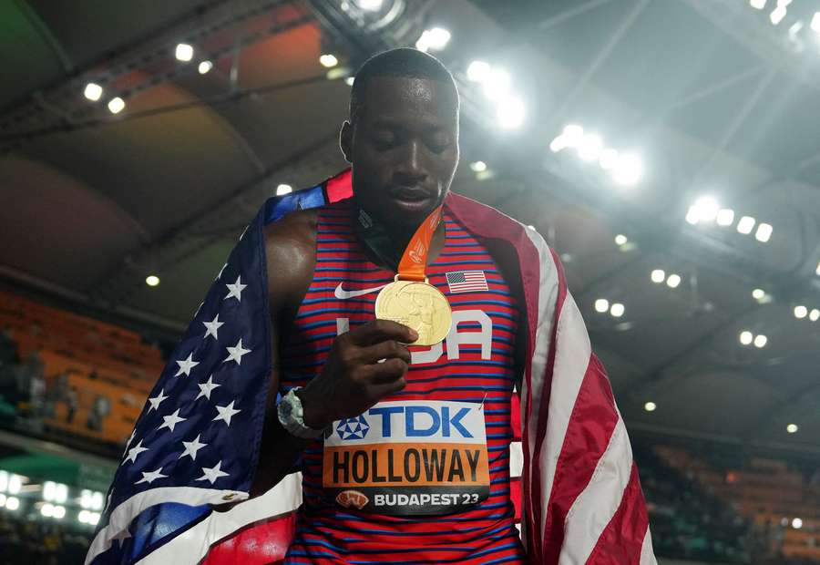 Grant Holloway shows off his gold medal after winning the 110m hurdles final