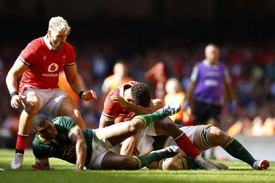 Wales' Rio Dyer and South Africa's Damian Willemse react after sustaining injuries