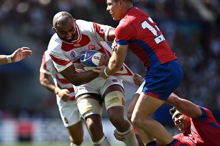 Japan flanker Michael Leitch is tackled as he runs with the ball