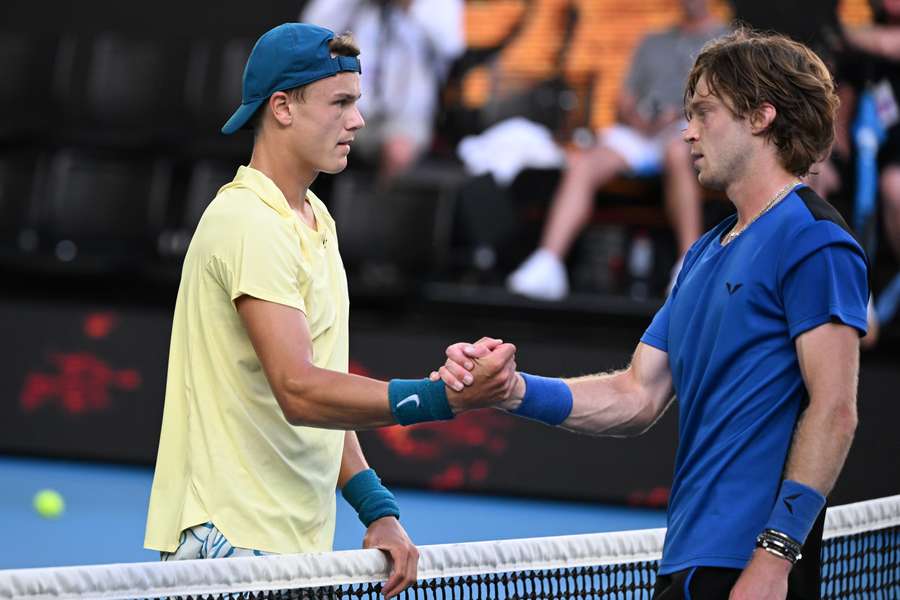 Russia's Andrey Rublev (R) greets Denmark's Holger Rune after winning their men's singles match