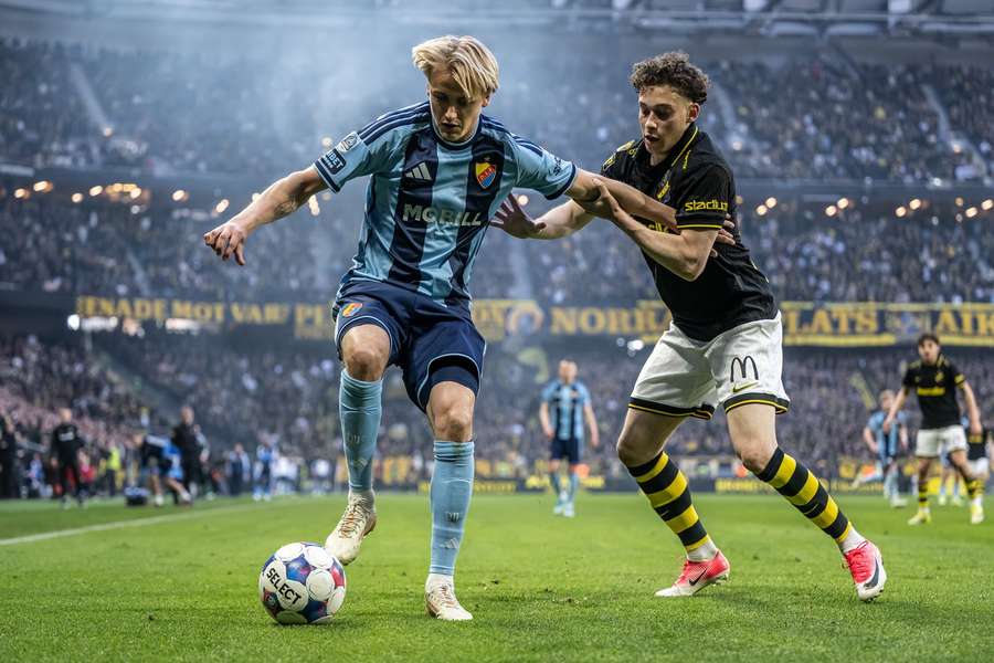 Djurgarden's Oskar Fallenius holds off AIKs Victor Andersson in the Tvillingderbyt