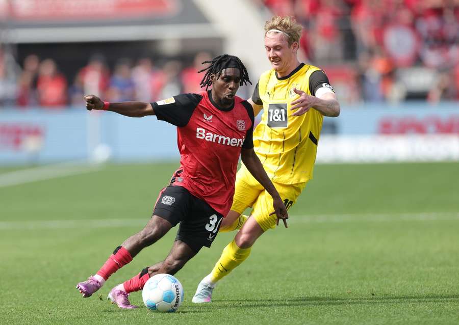 Jeremie Frimpong of Bayer Leverkusen and Julian Brandt of Borussia Dortmund compete for the ball Jeremie Frimpong of Bayer Leverkusen and Julian Brandt of Borussia Dortmund compete for the ball