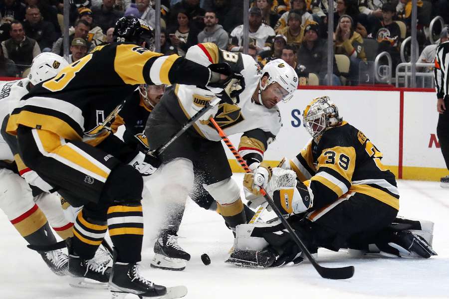 Penguins goaltender Alex Nedeljkovic makes a save against Golden Knights left wing William Carrier