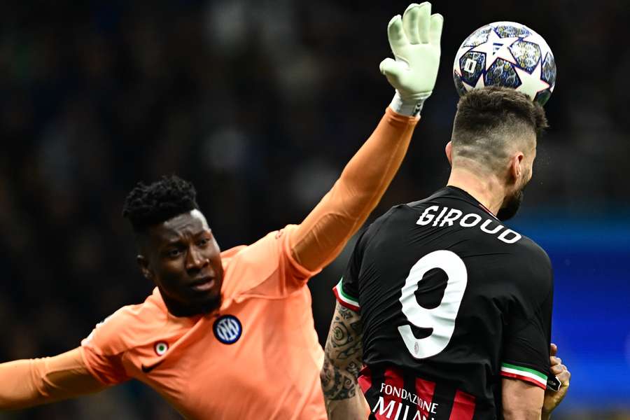 Olivier Giroud goes for a header against Andre Onana