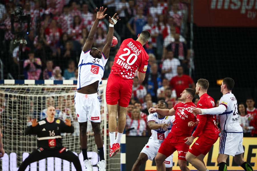 France's Karl Konan tries to block a shot from Croatia's right back Mateo Maras