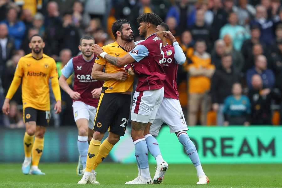 Diego Costa of Wolves and Tyrone Mings of Aston Villa clash during the Premier League match at Molineux