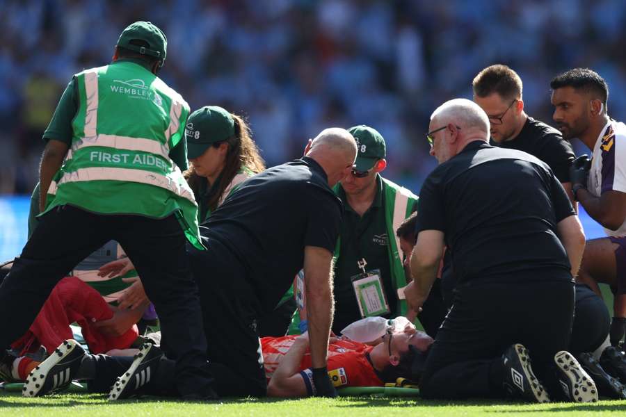 Tom Lockyer was treated by medical staff before he was taken to hospital