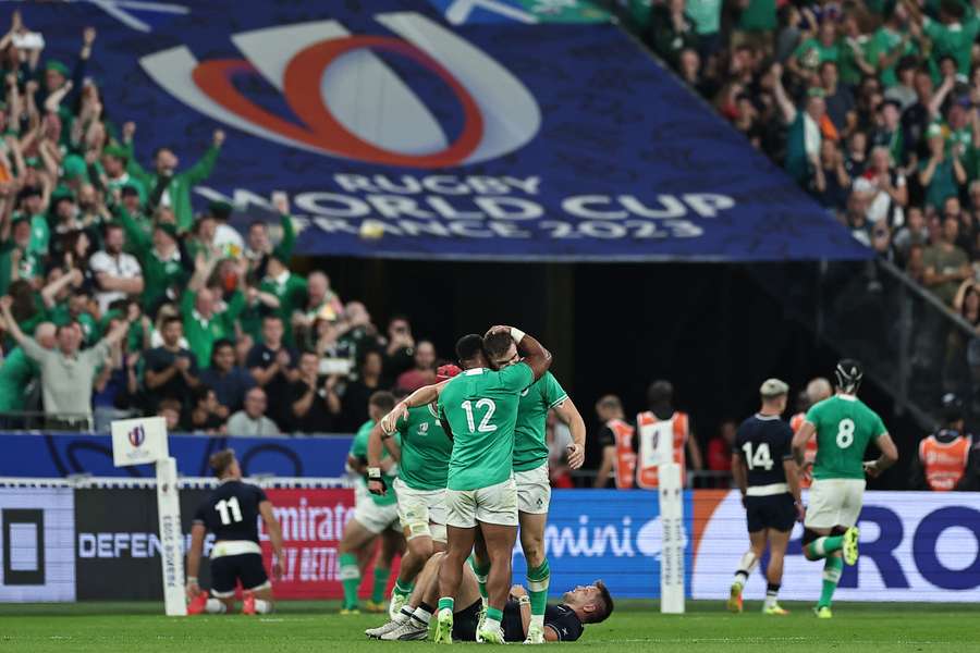 Ireland centre Bundee Aki (C) celebrates after a try