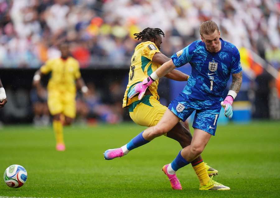 Pickford and Adu collide