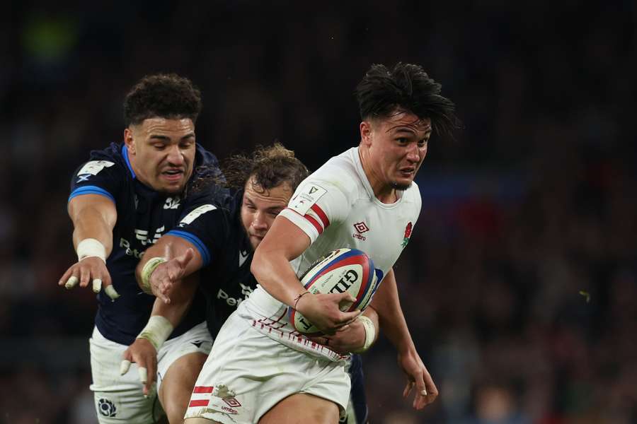 England's fly-half Marcus Smith is tackled by Scotland's centre Sione Tuipulotu