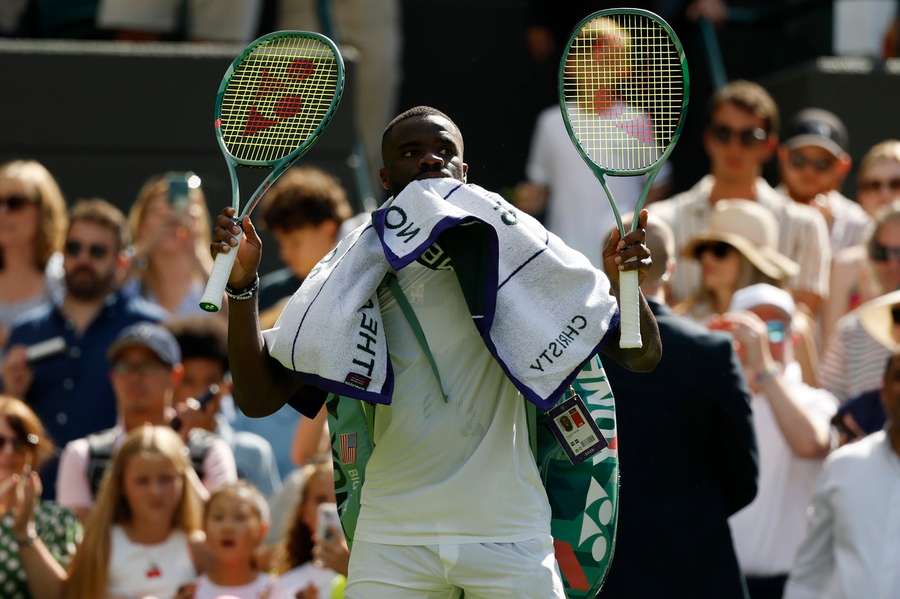 Frances Tiafoe waves to the crowd after his defeat