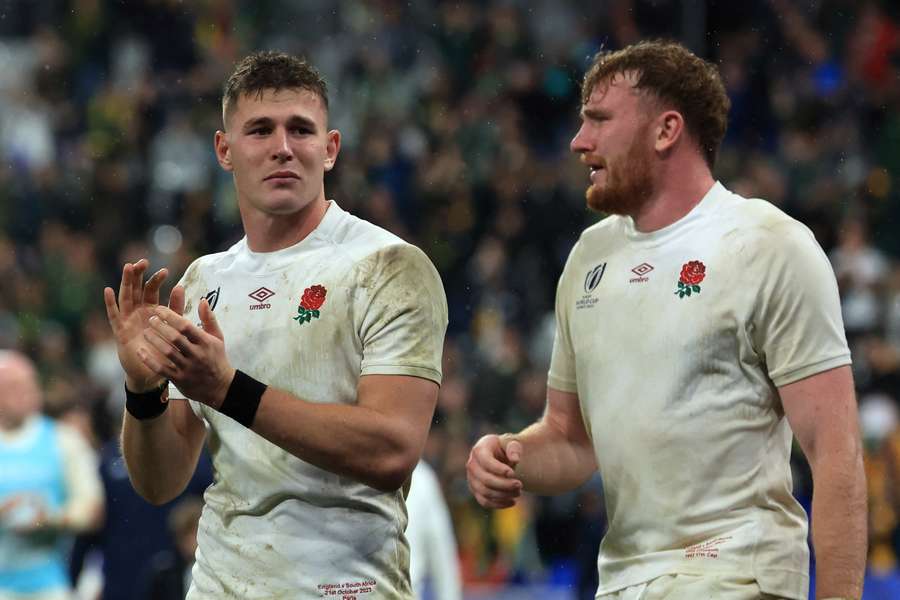 England full-back Freddie Steward (L) and lock Ollie Chessum react after losing the Rugby World Cup semi-final