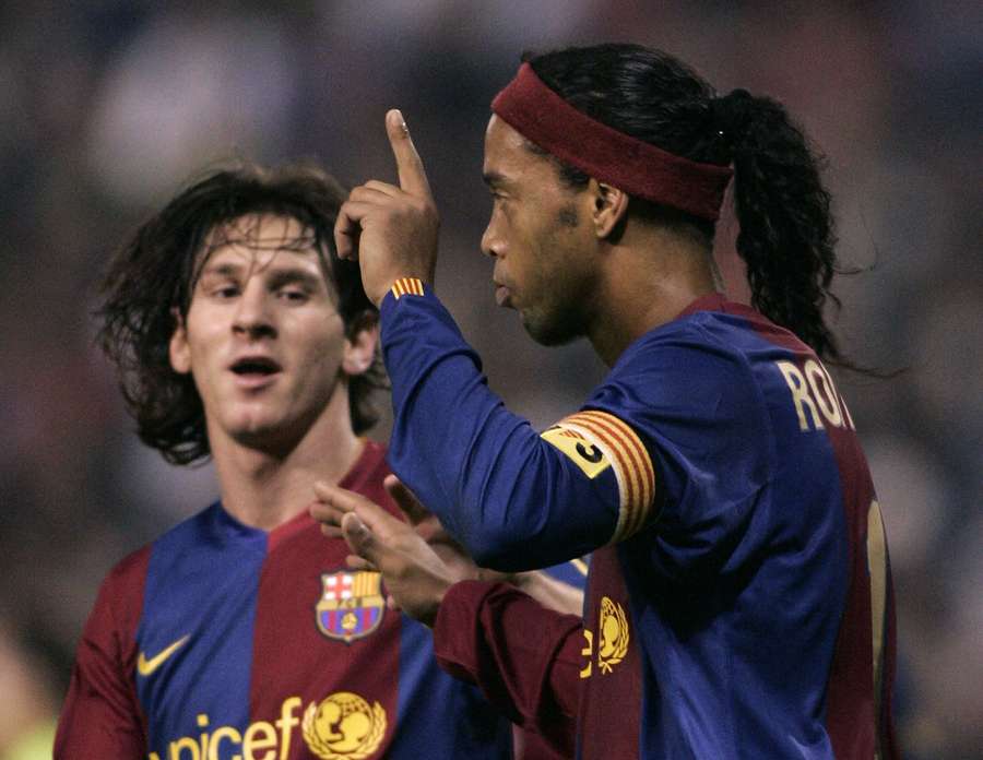 Ronaldinho (right) celebrates with Messi after scoring for Barcelona in 2006