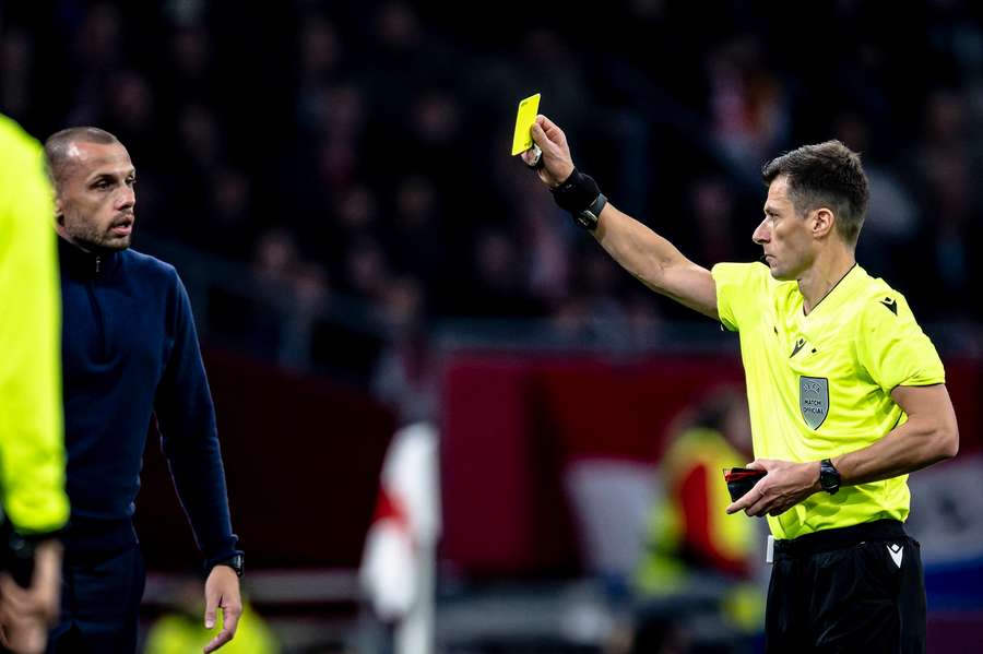 John Heitinga was given a yellow card in his final game in charge of Ajax John Heitinga was given a yellow card in his final game in charge of Ajax