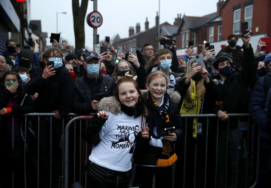 Young Marine fans queuing for their team's FA Cup clash with Spurs