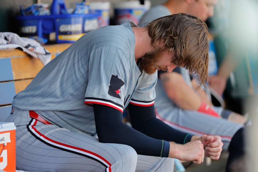 Minnesota Twins starting pitcher Bailey Ober sits in dugout in the ninth inning against the Detroit Tigers